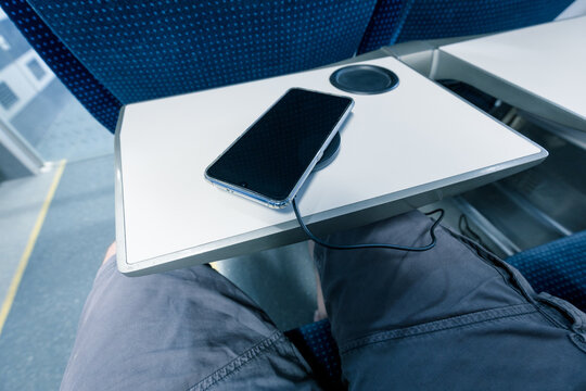 Charging The Phone With A Wireless Charger While Traveling By Train