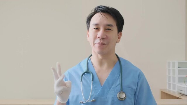 portrait of smart asian doctor explain and suggesting a way to takecare yourself with happiness smiling cheerful Caring for patients at the hospital