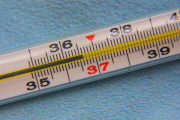 mercury thermometer on a blue background