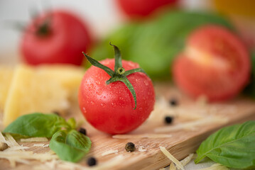 small fresh pink tomatoes with basil close-up