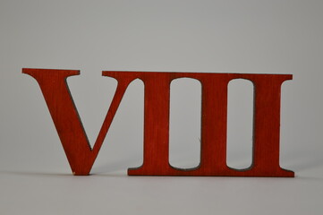 Wooden red roman numeral eight on a white background