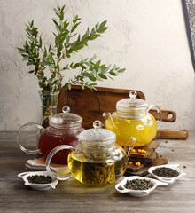 Different varieties of tea in  glass teapots 