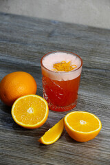 Bacardi cocktail with orange and orange zest on a gray background
