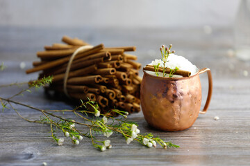 Christmas cocktail with crushed ice in a copper mug on a gray background