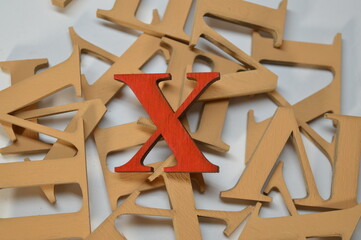 Wooden red roman numeral ten on a white background