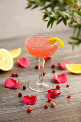 Cosmopolitan Cocktail with orange on a gray background