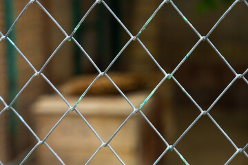 Mesh cage fence with wire behind, marine concept