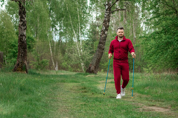 A man in a tracksuit is engaged in Nordic walking. The concept of a healthy lifestyle, cardio...