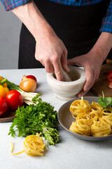 Men cooking sauce for pasta at the kitchen, making food