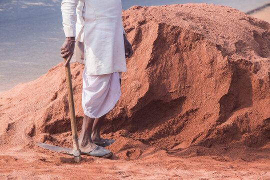Image of worker on site location with spade 