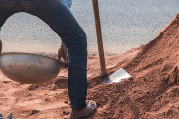 Image of worker on site location with spade 