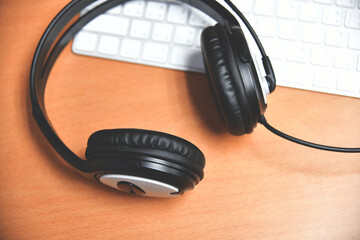 Black headset on table of technical support agent in office