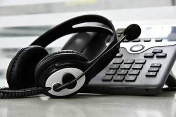 Black headset on table of technical support agent in office