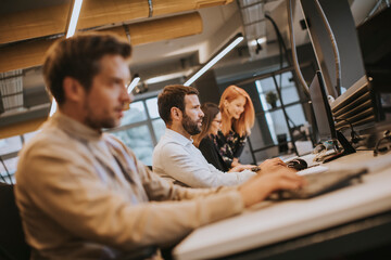 Young professional businessman uses a computer for work in the office