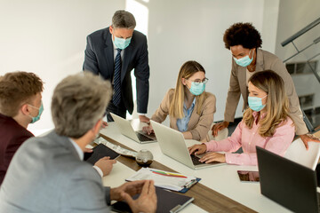 Group business people have a meeting and working in office and wear masks as protection from corona virus