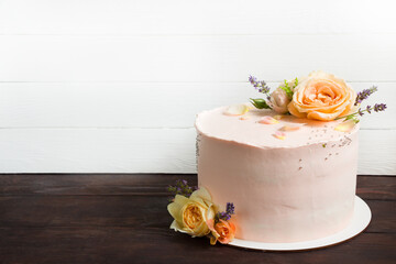 Beautiful roses cake on wooden board Peach roses and lavender cake, Concept for Wedding , St. Valentine's Day, Mother's Day, Birthday Cake. White background