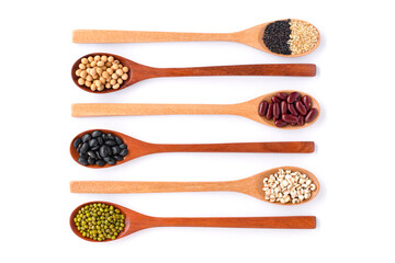 Different or various types of dry beans or dried legumes in wooden spoon isolated on white background. Whole grains ,healthy food and diet concept. Top view. Flat lay.