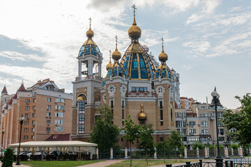 Fototapeta na wymiar Kyiv (Kiev), Ukraine - July 04, 2020: Church of the Nativity near residential buildings