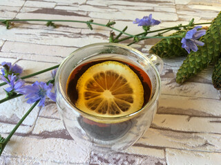 black tea with lemon in a transparent cup