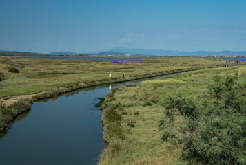 Obraz premium Unrecognizable tourists walking in a natural park in Tuscany, Italy, after covid-19 quarantine, in a concept of exploring and social distancing
