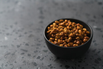 dried seaberry buckthorn in black bowl on terrazzo countertop with copy space