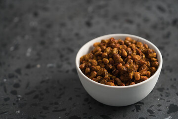 dried seaberry buckthorn in white bowl on terrazzo countertop with copy space