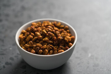 dried seaberry buckthorn in white bowl on terrazzo countertop with copy space
