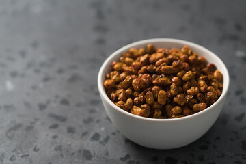 dried seaberry buckthorn in white bowl on terrazzo countertop with copy space