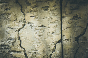 Cracked stone wall. The background.