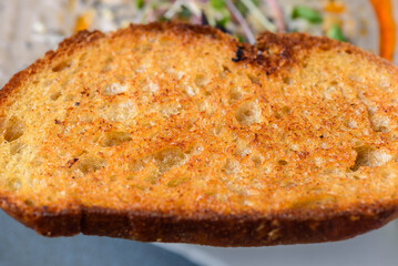 A close view of a slice of toasted bread as know as 'Toast'
