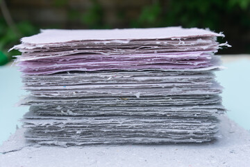 A stack of handmade paper. Waste paper recycling.