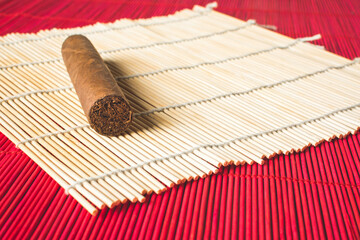 Havana cigar on white bamboo mat.