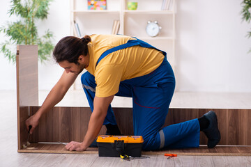 Young male carpenter working indoors