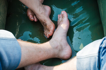 Fototapeta na wymiar Male and female legs in rubber boat fishing.