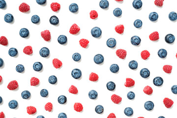 Fruit pattern of colorful wild berries isolated on white background. Raspberries and blueberries . Top view. Flat lay