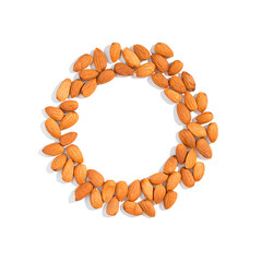 Round frame circle made of almond seeds isolated over the white background