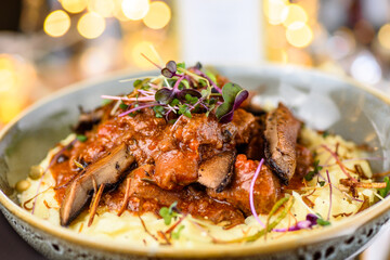 A serving of Beef Bourguignon, with speck, glazed mushrooms and mashed potato