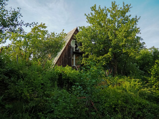 Obraz premium photo of an old abandoned house on an overgrown plot