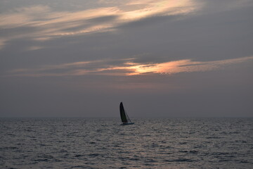 silhouette of a sailboat at sunset