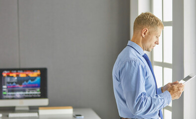 Fototapeta premium Young woman working with graphic tablet in office
