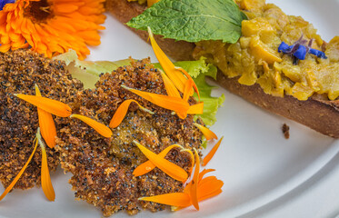 appetizer of calendula flowers and crouton. Plate decorated with fresh flowers. Flower food concept. edible summer flowers