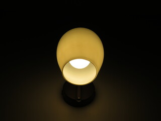 A small, luminous lamp at night at home