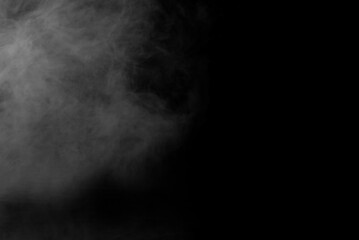 White smoke on a black background. The texture of scattered smoke. Blank for design. Layout for collages.