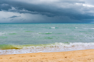 huge clouds during a hurricane on Koh Samui in Thailand, on the horizon there is a lone ferry,...