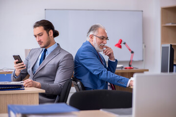 Two male employees working in the office