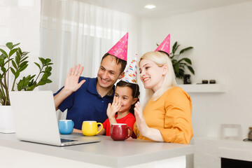 Happy family celebrating birthday via internet in quarantine time, self-isolation and family...