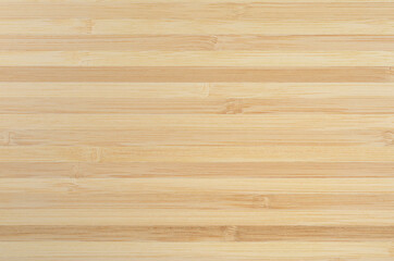 Texture of the surface assembled from bamboo planks. Background of a wooden cutting Board.