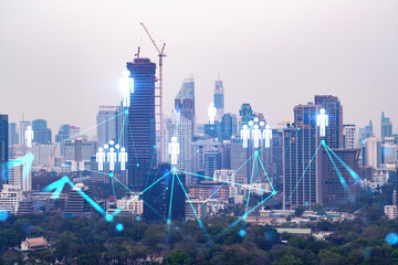 Social media icons hologram over panorama city view of Bangkok, Asia. The concept of people...