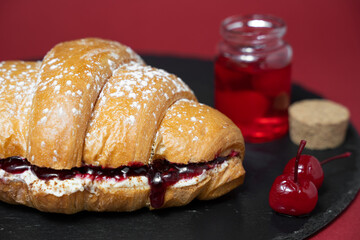 close up photo of croissant with cherries and ingredients