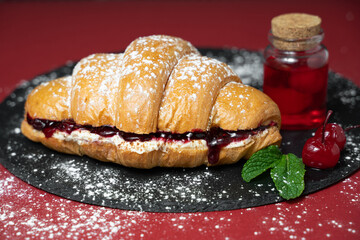 close up photo of croissant with cherries and ingredients